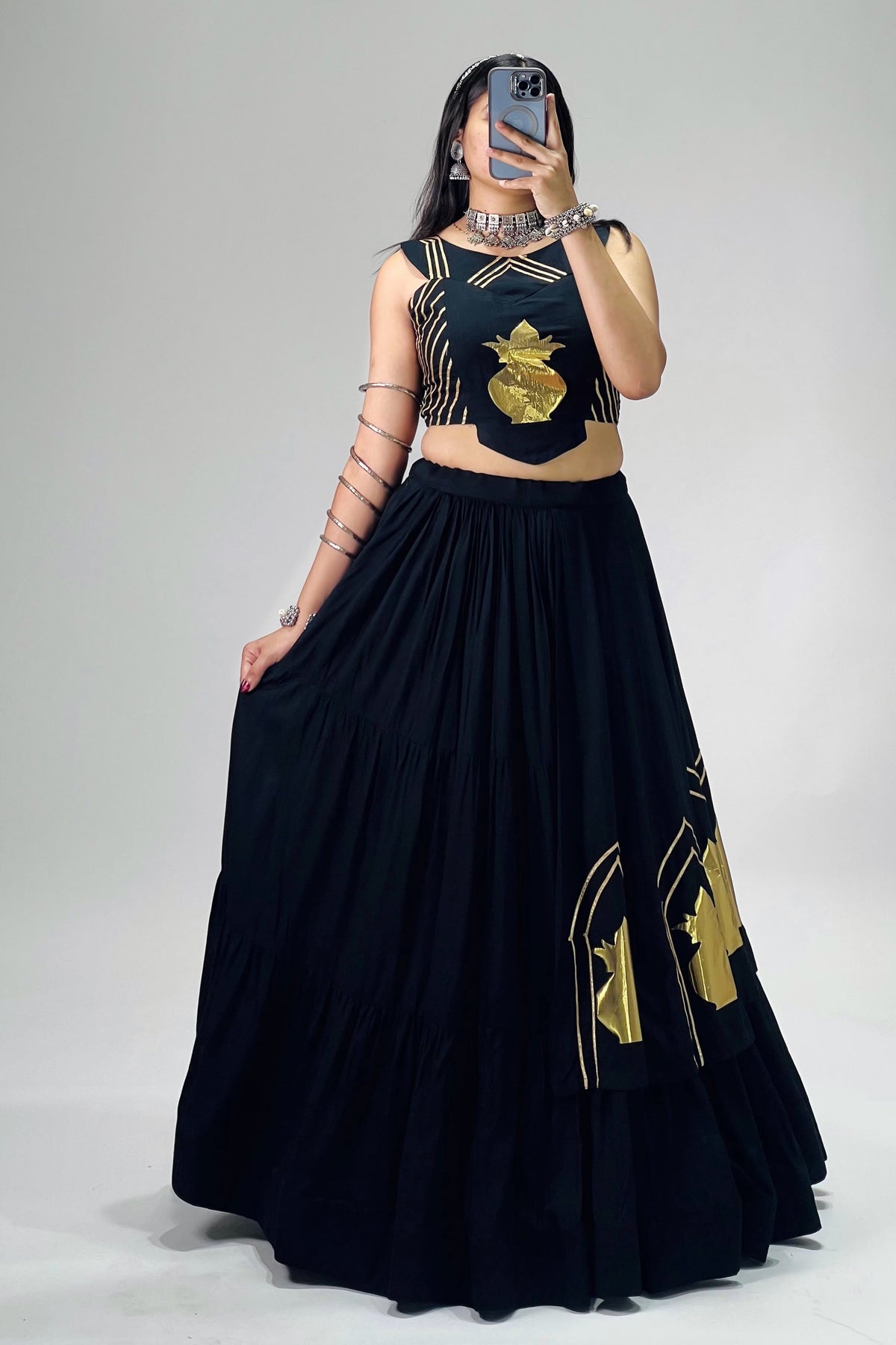 Black lehenga choli with golden Kalash motifs and traditional festive detailing