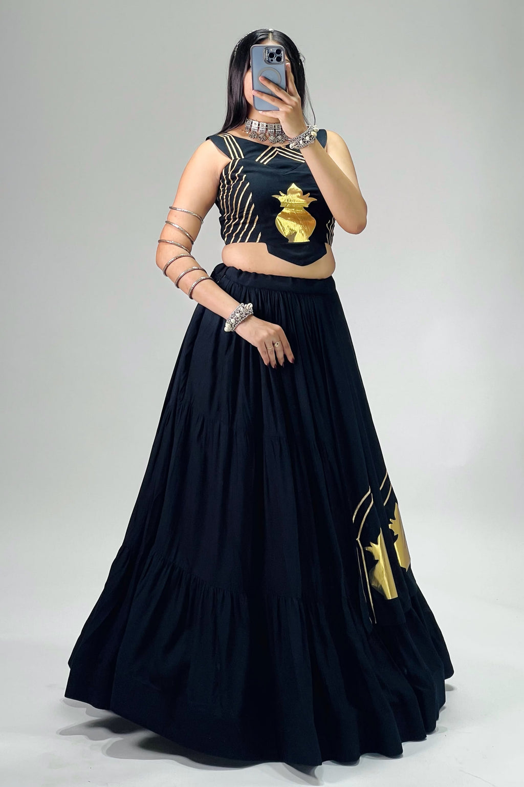 Black Navratri chaniya choli featuring golden detailing and fully stitched blouse