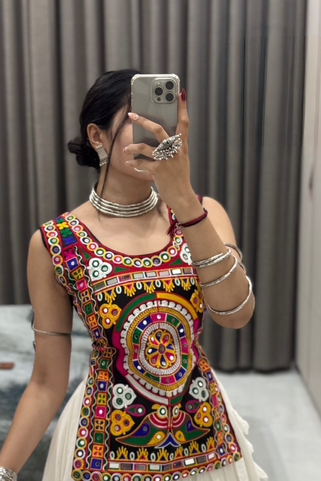 Close-up view of colorful embroidered Kediya Choli detailing with traditional motifs and a round neckline