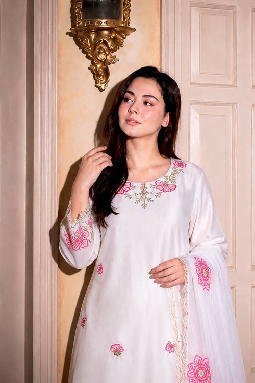 Close view of white Farshi Shalwar Suit neckline with floral embroidery and sequin detailing
