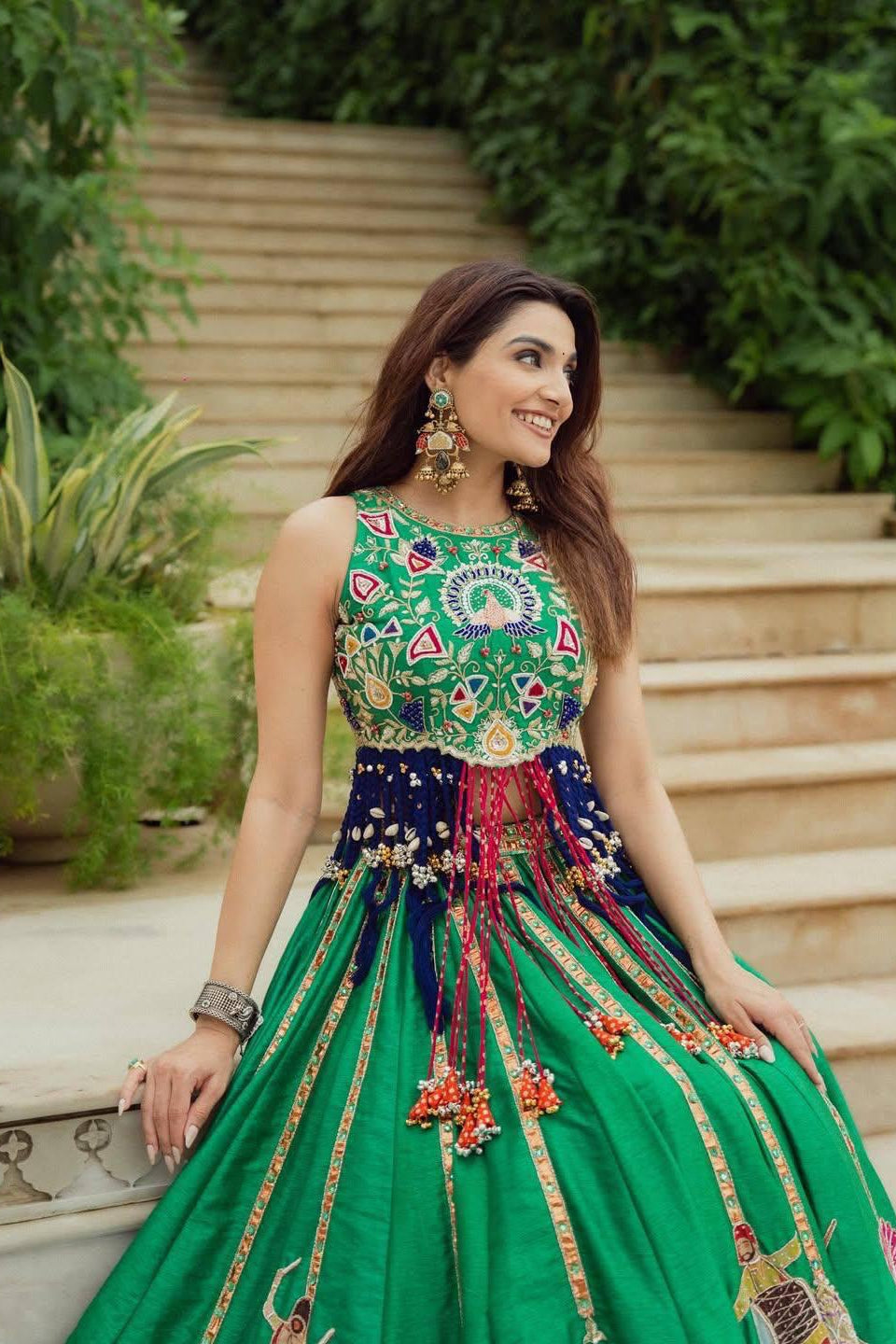 Green digital print lehenga showing detailed motifs and decorative skirt border