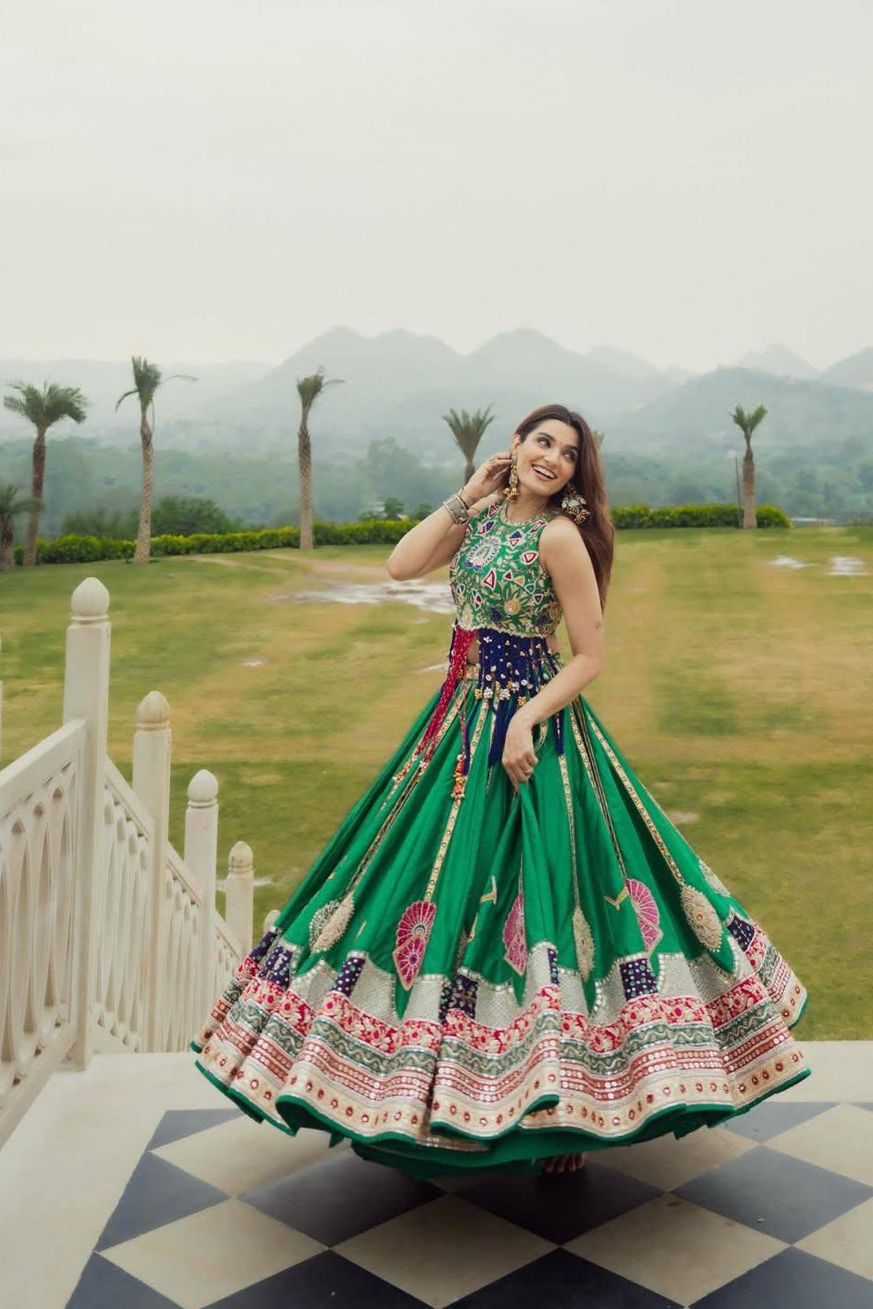 Close view of green lehenga choli bodice with colourful printed design