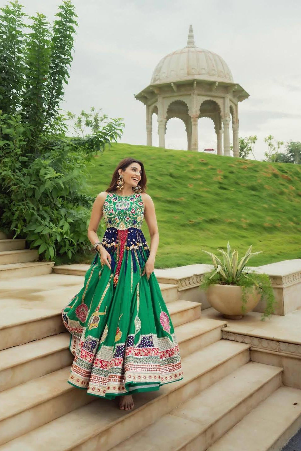 Green lehenga choli with matching printed dupatta and colourful decorative details