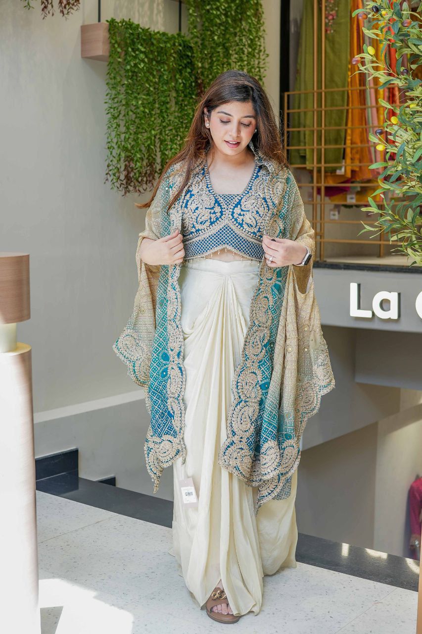 Full view of an Indo Western dhoti set with ivory dhoti, embroidered blouse and flowing shrug