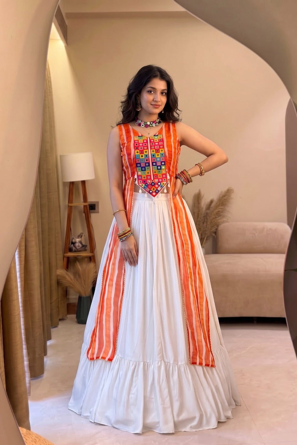 White Leheriya lehenga set styled with colorful mirror work festive top