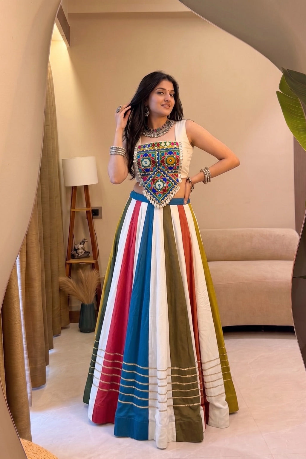 Multicolor Gamthi lehenga choli shown from an angled view with colorful striped rayon skirt