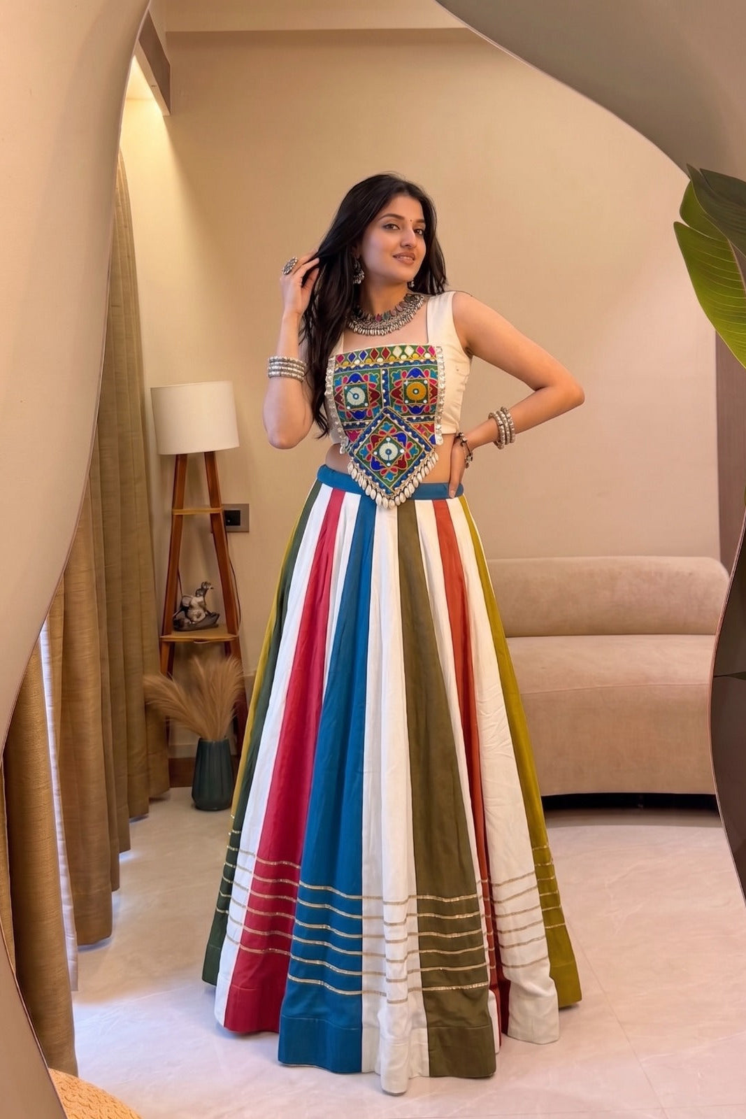 Multicolor Gamthi lehenga choli shown from an angled view with colorful striped rayon skirt