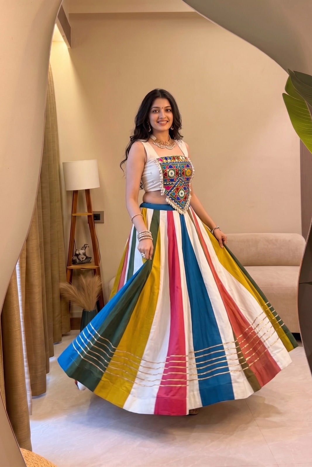 Multicolor lehenga choli with vibrant striped skirt and Gamthi mirror work blouse styled for Garba