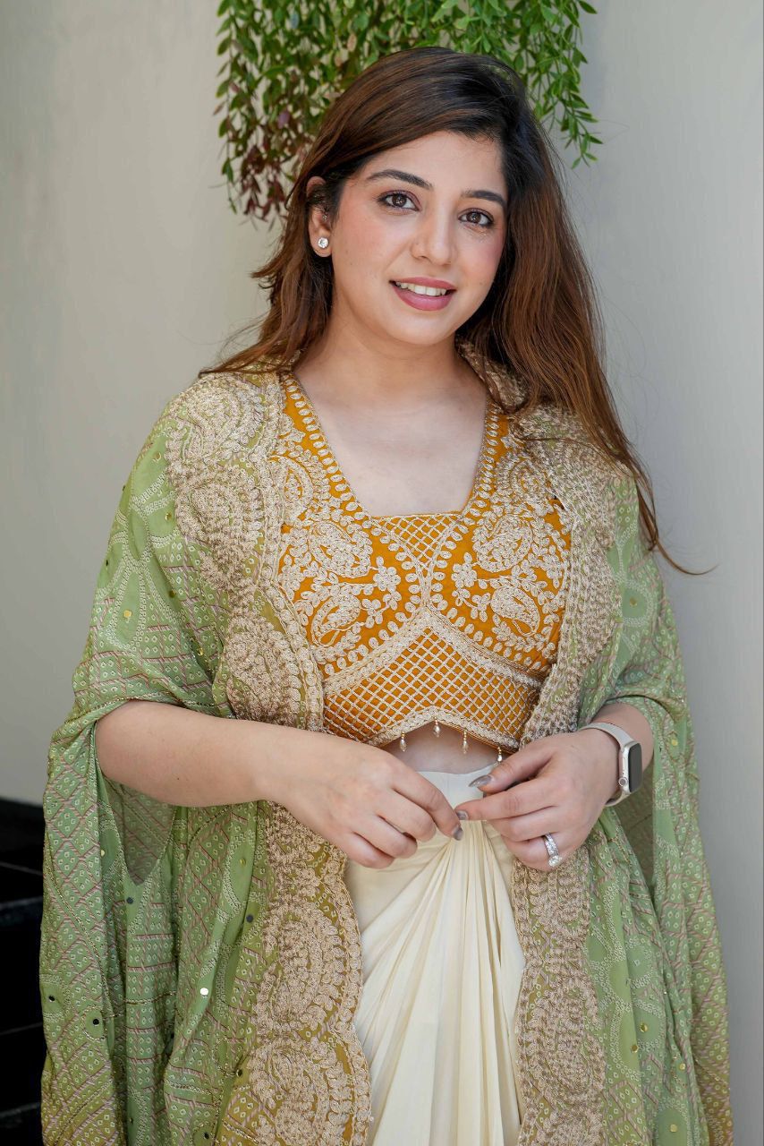 Mustard embroidered blouse from a three-piece Indian dhoti set with detailed neckline and cording work