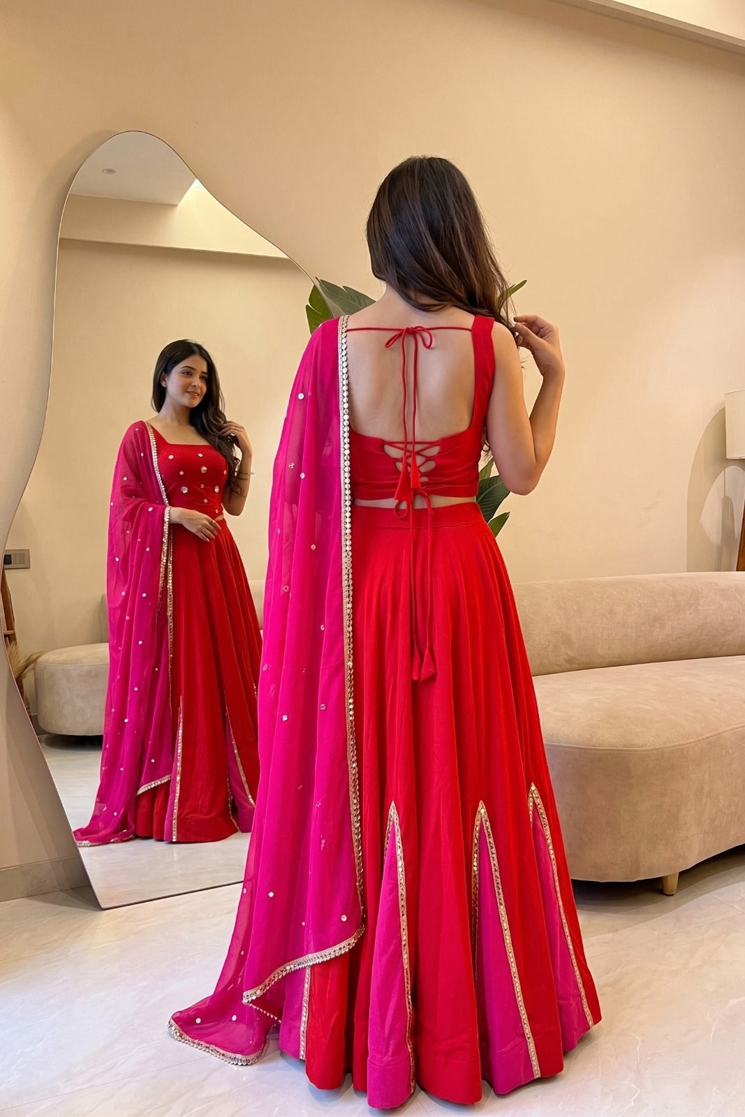 Back view of red Navratri lehenga choli with tie-up blouse and pink dupatta