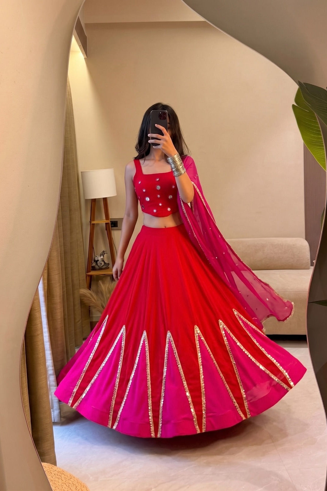 Flared red and pink Navratri lehenga choli with decorative mirror work panels