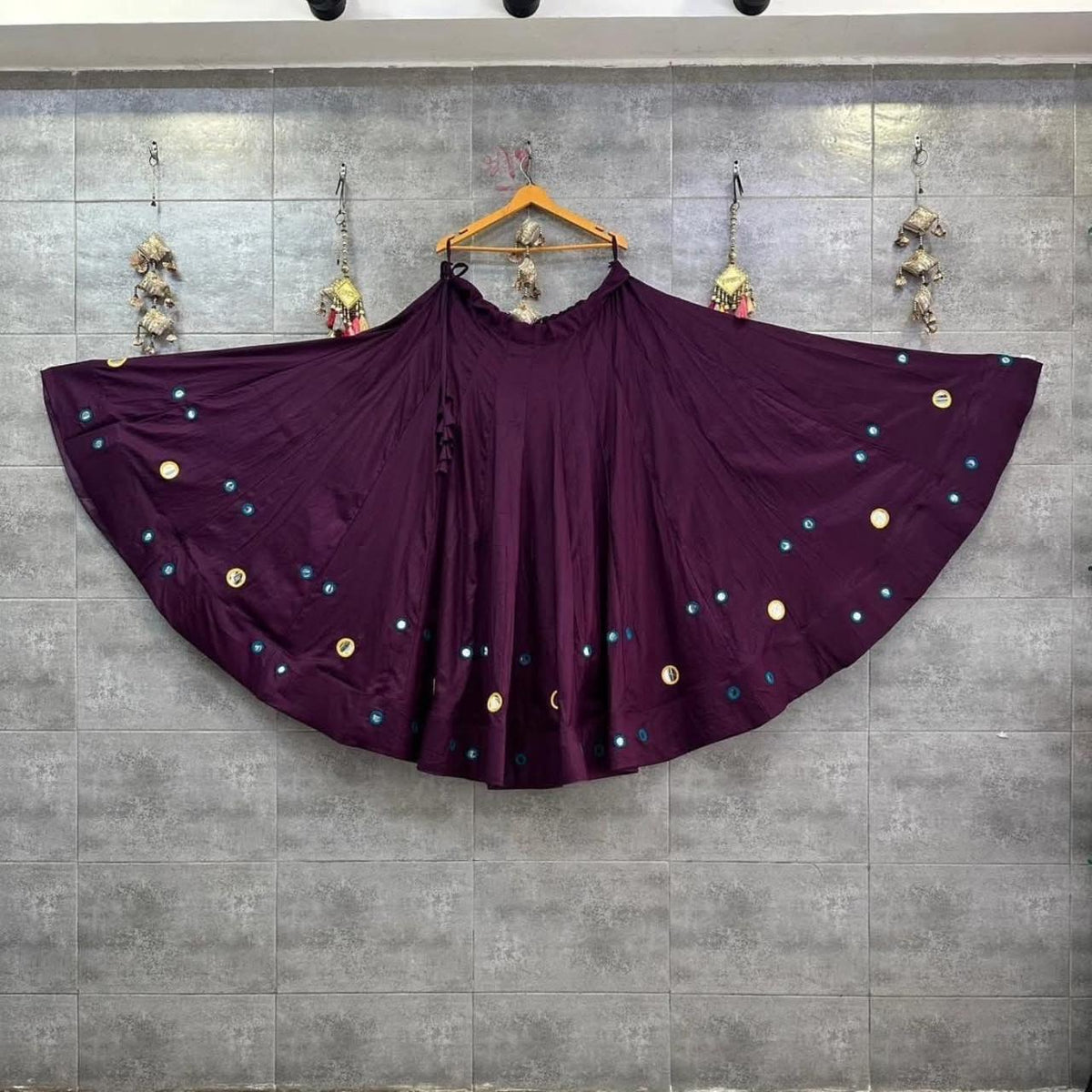 Plum purple Chaniya Choli with colourful embellishments and traditional Indian design