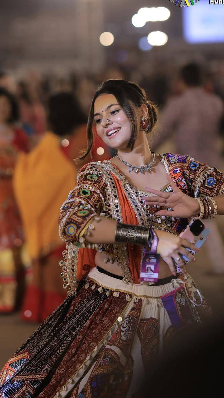 Colourful printed mirror work lehenga choli worn as a Navratri and Garba outfit
