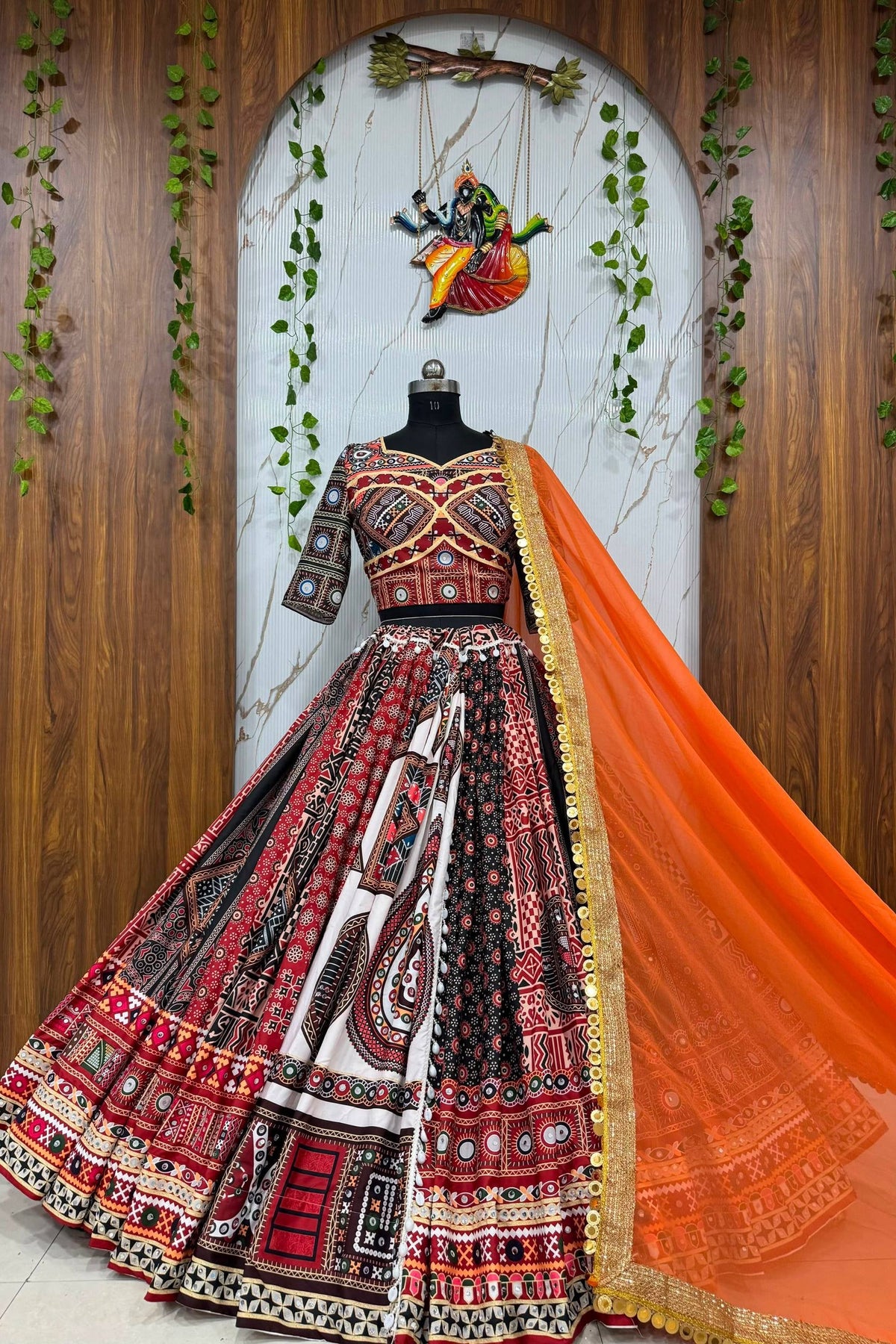 Printed mirror work lehenga choli with orange Georgette dupatta and colourful traditional print
