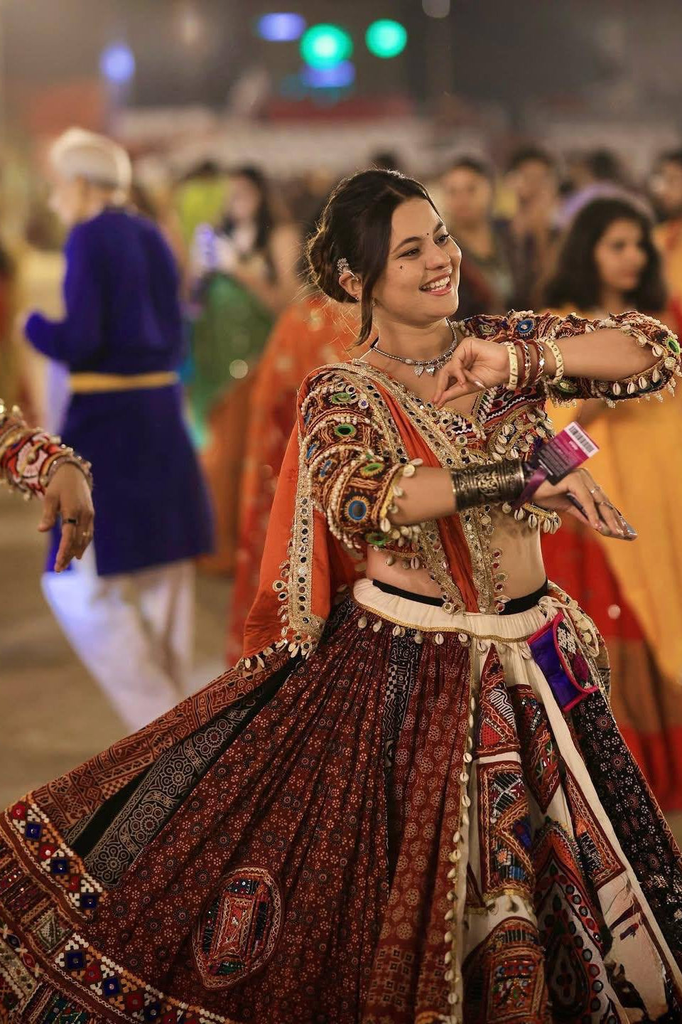 Traditional printed mirror work lehenga choli featuring colourful patterns and ethnic detailing