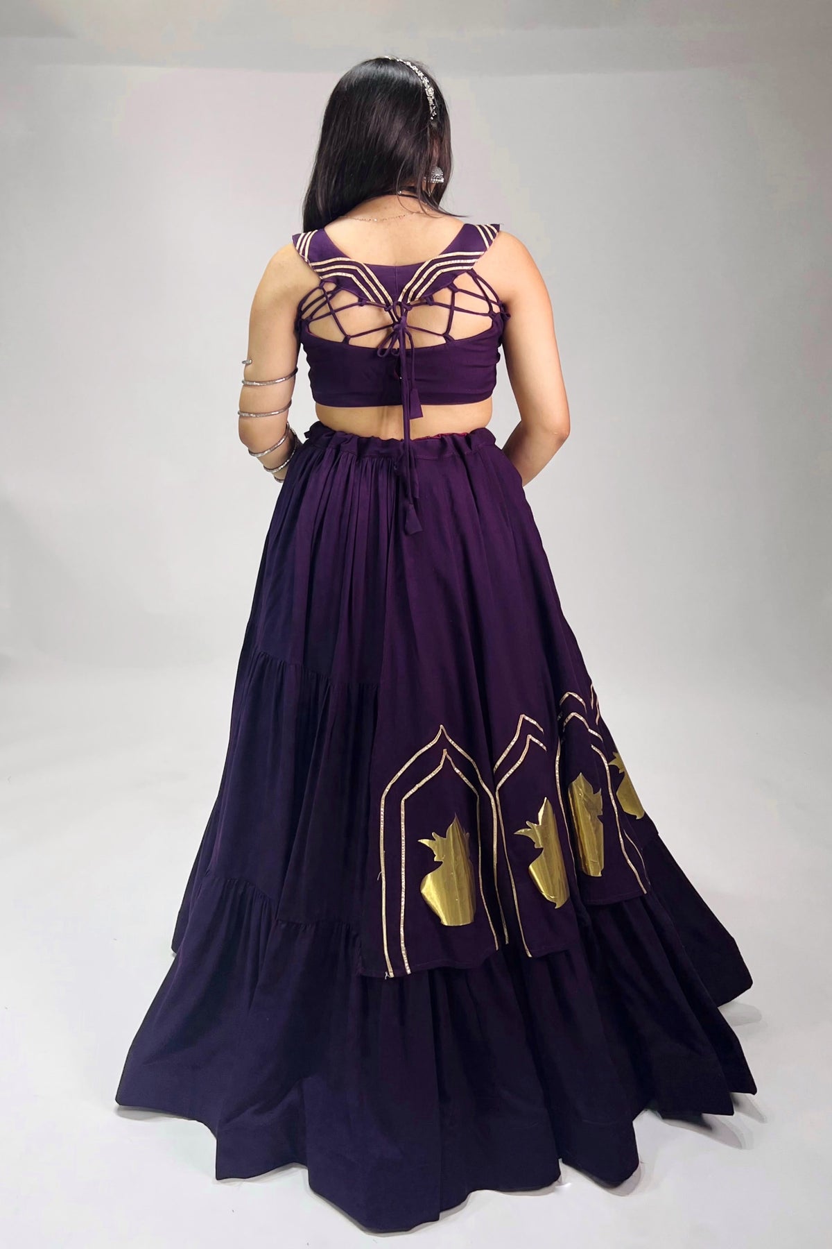 Back detail of purple chaniya choli with dori closure and coordinated detailing