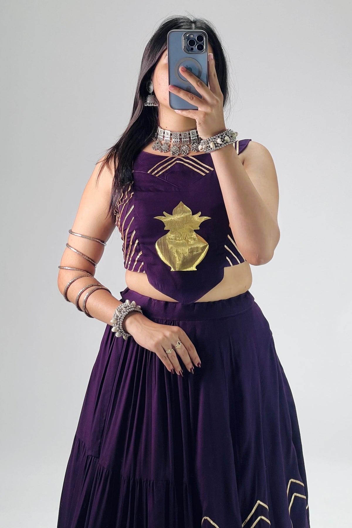 Close-up of purple rayon cotton lehenga and golden Kalash design details