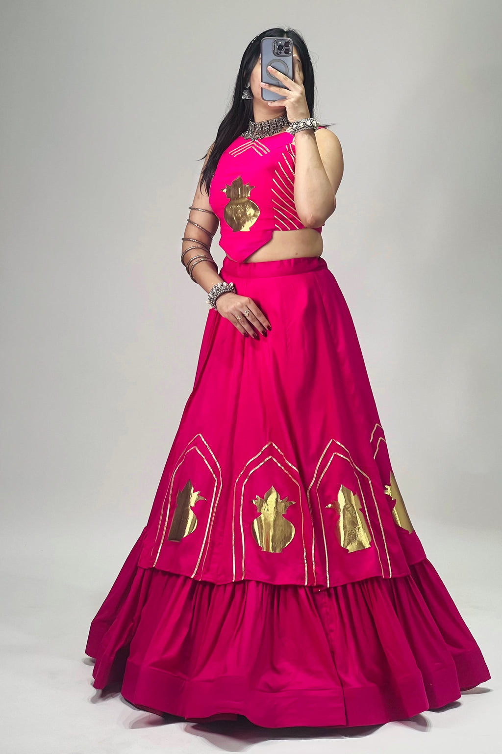 Rani pink Navratri chaniya choli set with golden Kalash motifs, stitched blouse and 6 meter lehenga flair