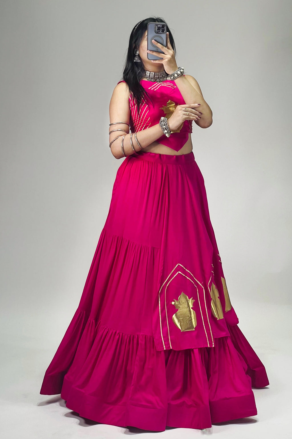 Side view of Rani pink rayon cotton lehenga choli showing golden Kalash patches and layered skirt design