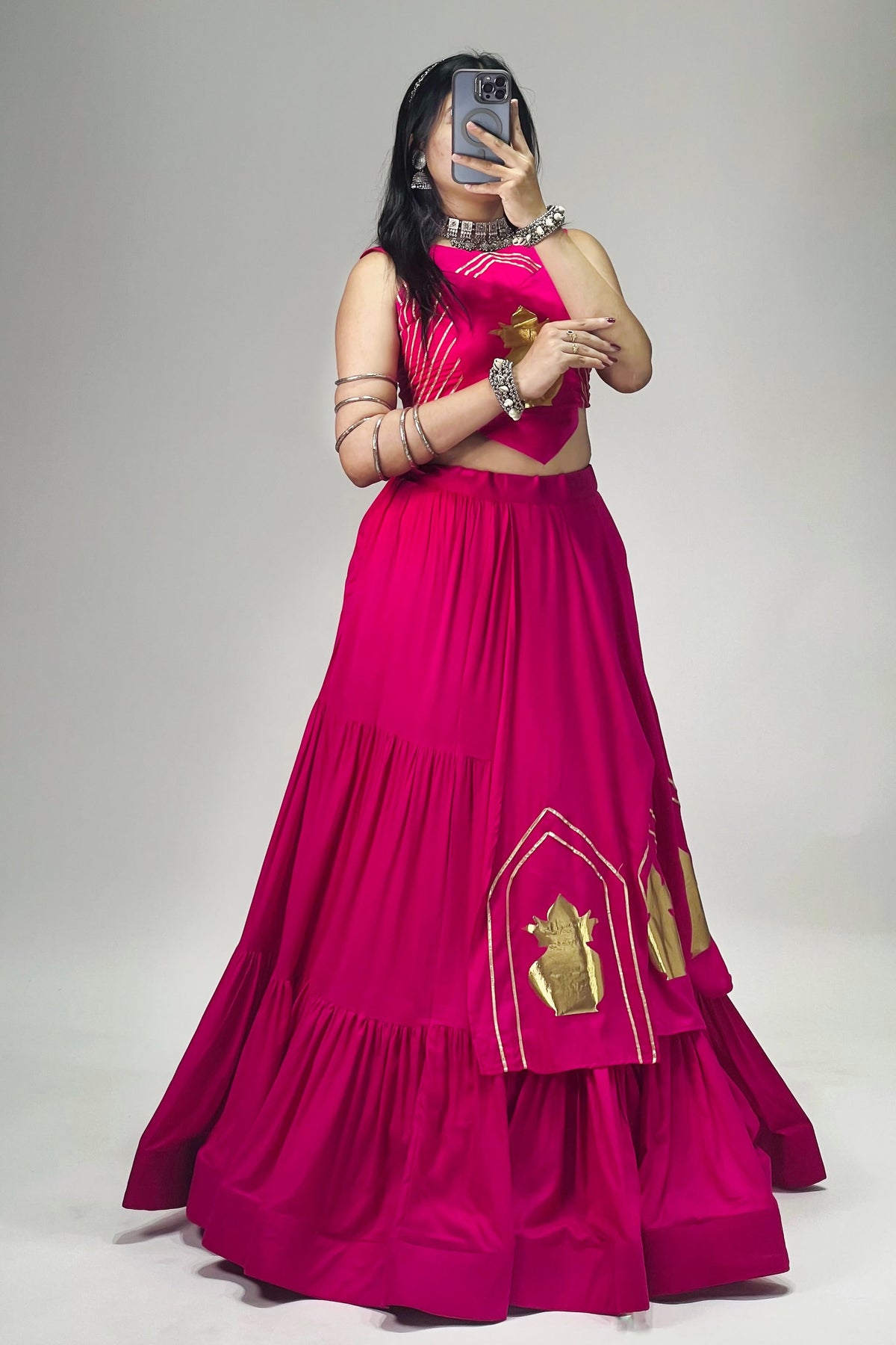 Side view of Rani pink rayon cotton lehenga choli showing golden Kalash patches and layered skirt design