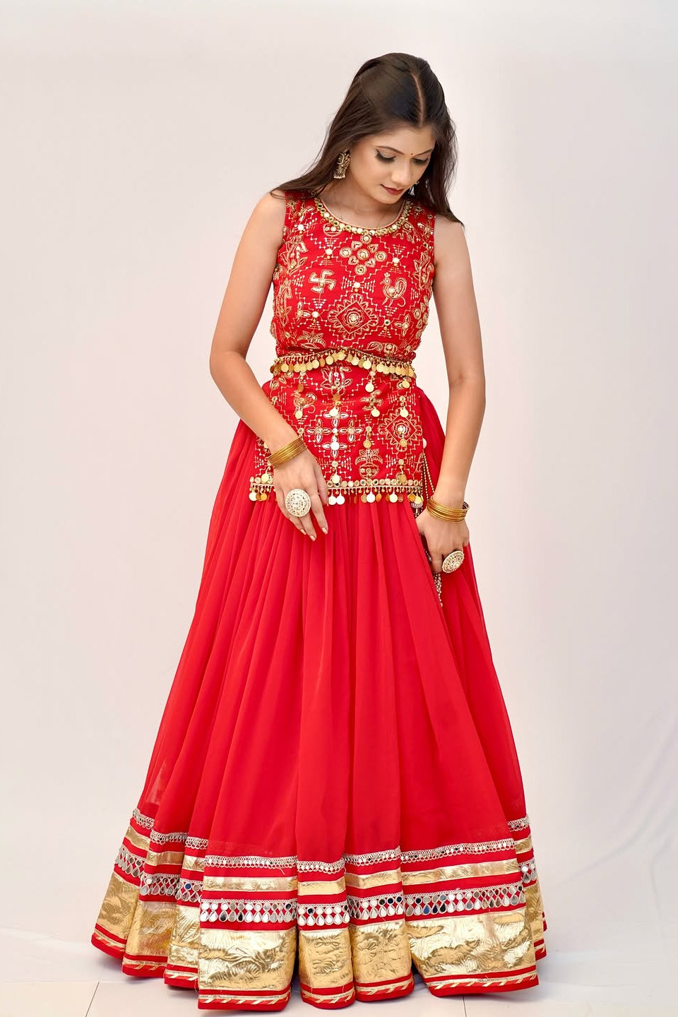 Red lehenga choli front view with embroidered choli and ornate gold lace border