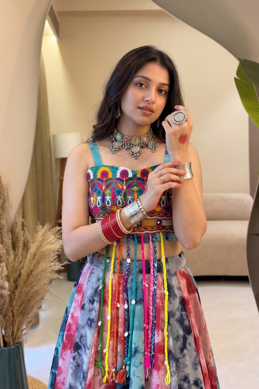 Close-up of colorful Shibori lehenga with detailed Gamthi work fancy top