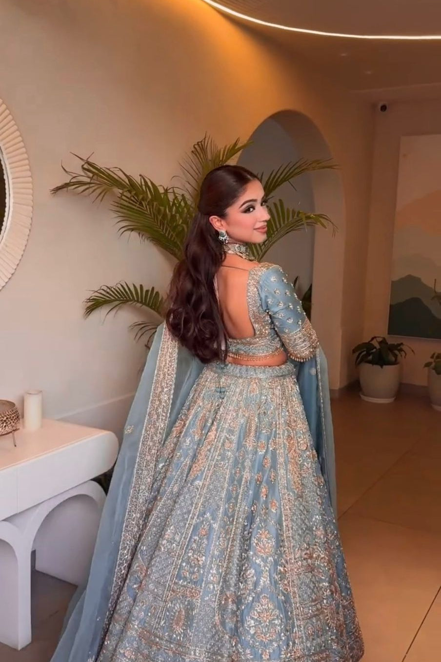 Back view of slate blue Indian lehenga choli with detailed blouse and skirt work
