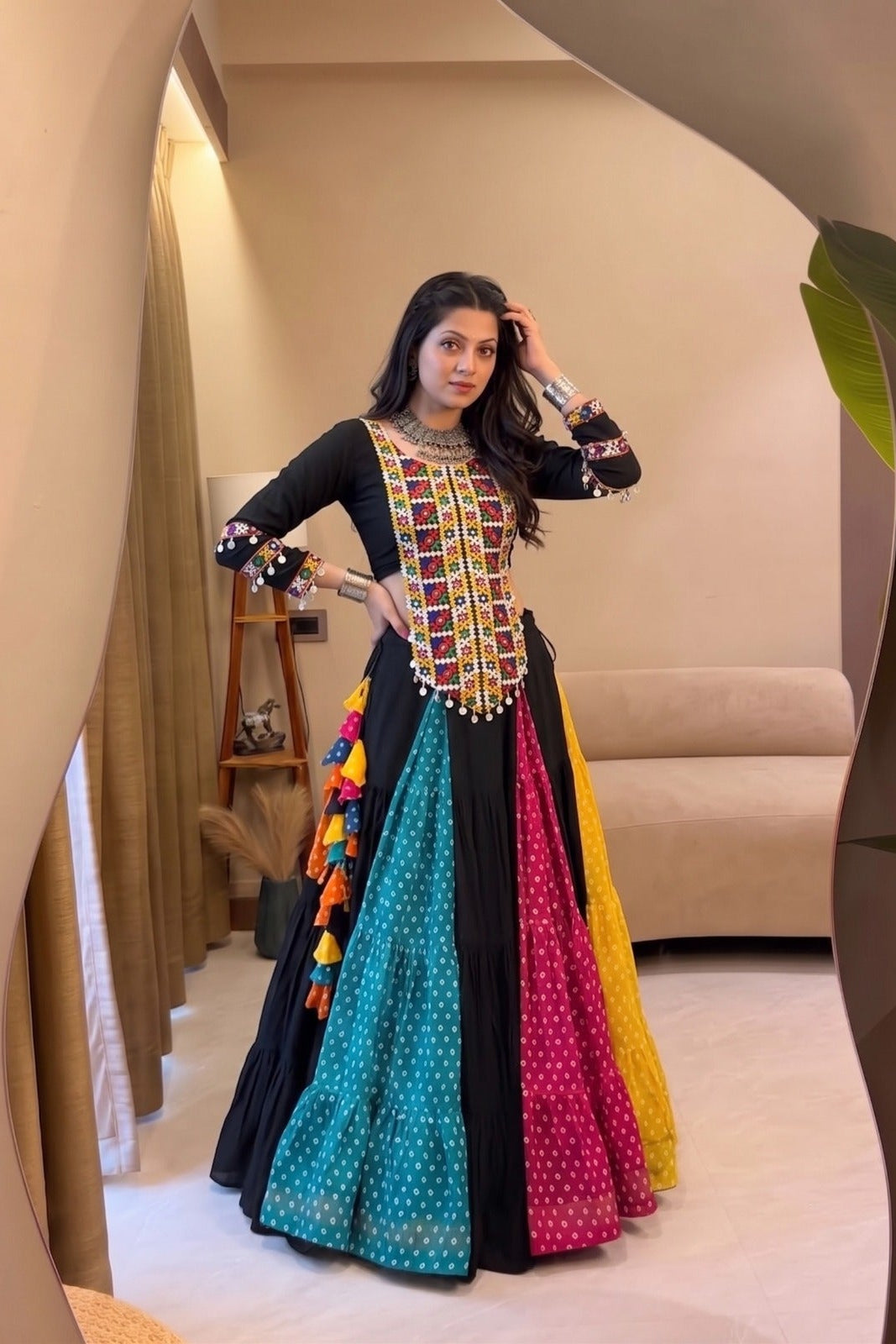 Traditional black lehenga choli with Kutchhi work and colorful festive panels
