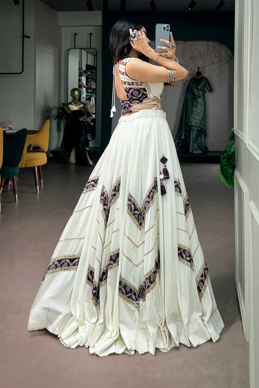White Navratri lehenga choli back view with printed blouse and festive tassel details