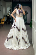 White rayon Garba lehenga choli showing the flowing skirt and detailed blouse back