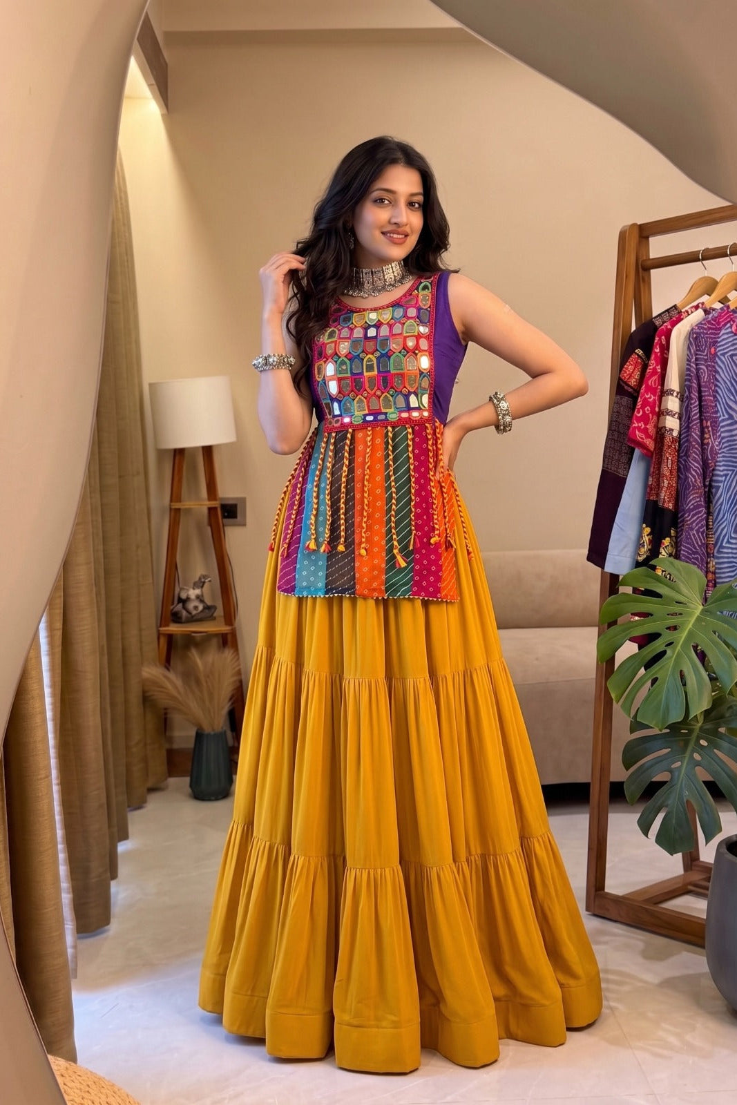 Yellow Navratri lehenga with sleeveless mirror work and Bandhani patchwork blouse
